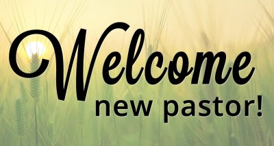 Background of sunrise over wheat field; text says "Welcome new pastor."